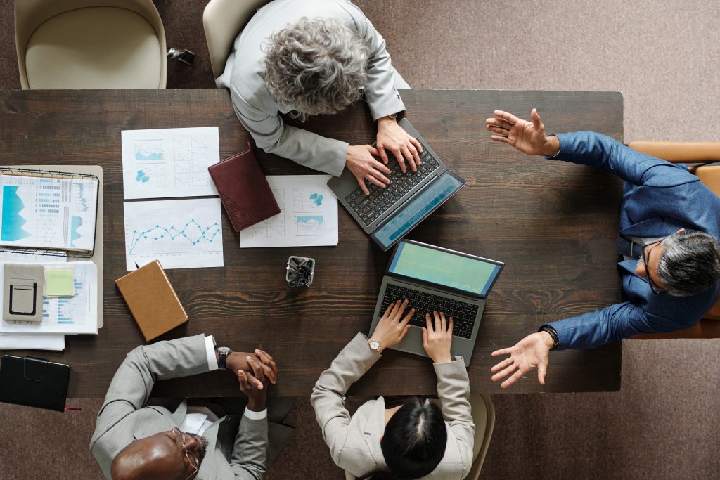 diverse middle aged business team collaborating during office meeting
